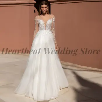 Элегантное свадебное платье с вырезом лодочкой 2023 для невест с длинным рукавом, шлейфом, пуговицей А-силуэта сзади и аппликацией из пайеток.